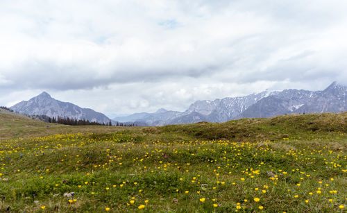 Scenic view of mountains against cloudy sky