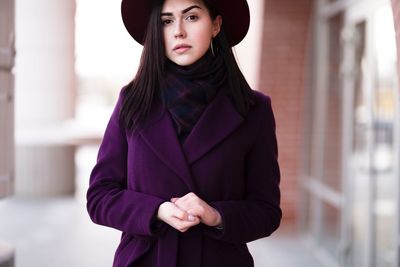 Portrait of young woman wearing hat