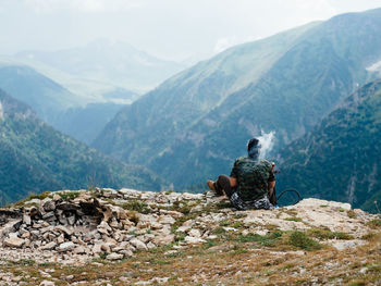 Rear view of people riding on mountain