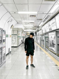 Full length of man standing on tiled floor