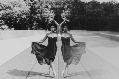 Ballet dancer standing by glass window