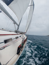 Boat sailing on sea against sky