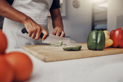 Midsection of man working on table