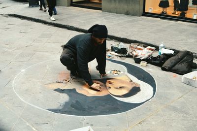 Full length of man skateboarding on street