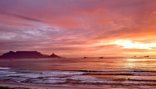 Scenic view of sea against orange sky