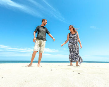 Friends standing at beach