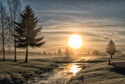 Scenic view of landscape against sky at sunset