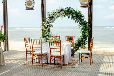 Empty chairs and tables at beach