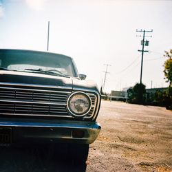 Surface level of car parked on road against sky