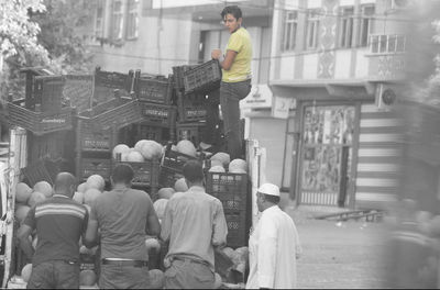 Rear view of people on street in city