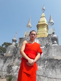 Full length of man standing outside temple against building