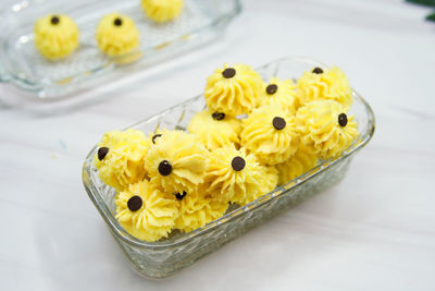 High angle view of yellow flowers on table