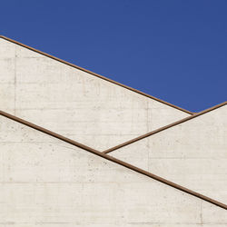 Low angle view of building against clear blue sky