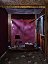 Empty chairs and table in building