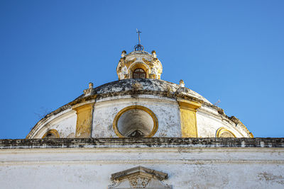 Low angle view of historic building against clear blue sky