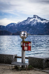 Close-up of coin operated binoculars by lake