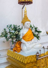 Sculpture of buddha statue outside building