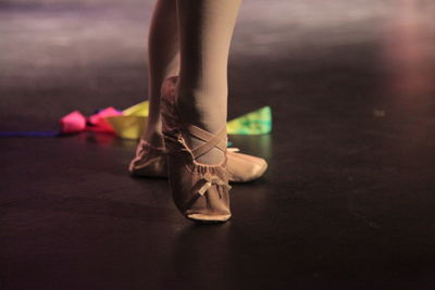 Low section of ballet dancer standing on stage 