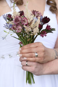 Close-up of hand holding flower bouquet