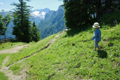 Rear view of child walking on austrian alpine mountain