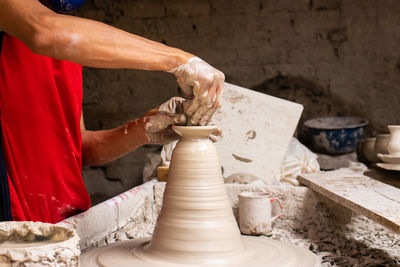 Midsection of potter working in factory