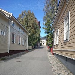 Empty road with buildings in background