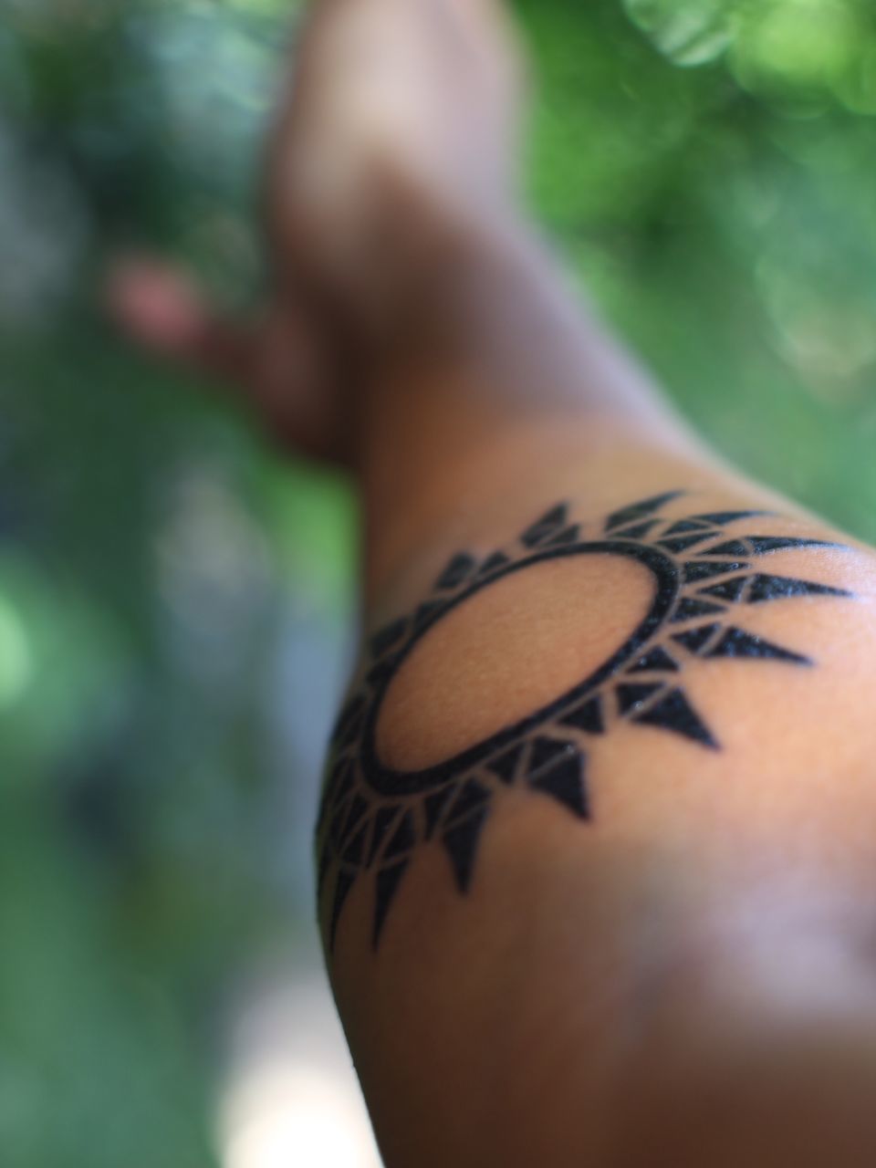 CLOSE-UP OF HUMAN HAND WITH TATTOO ON FINGER