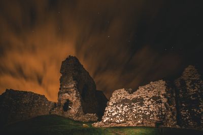 Rock formation against sky at night