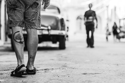 Low section of man standing on street