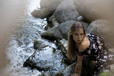 Portrait of young woman on rock