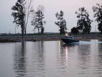 Boat sailing in river against sky