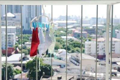 Close-up of clothes drying hanging on window