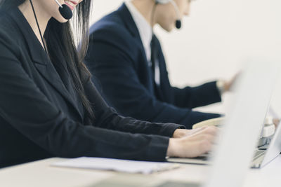 Midsection of man using mobile phone