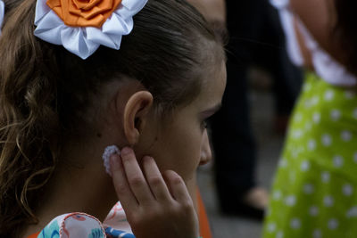 Side view of girl wearing earring outdoors