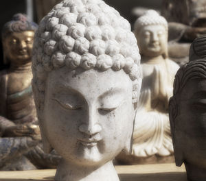 Close-up of buddha statue against temple