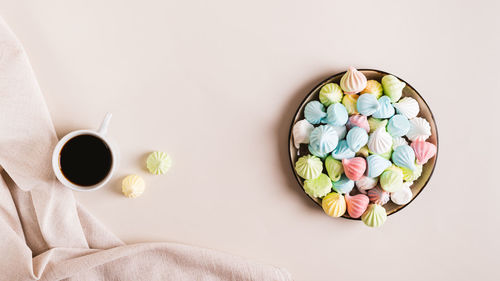 Sweet small meringues for dessert on a plate on the table top view web banner