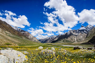 Scenic view of mountain range against cloudy sky