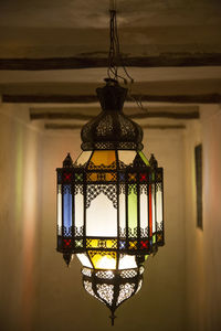 Illuminated pendant light hanging from ceiling