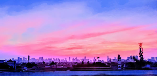 Panoramic view of city buildings against sky during sunset