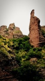 Low angle view of rock formation against sky