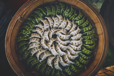 Directly above shot of chinese dumplings arranged in container at market stall