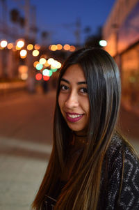 Close-up portrait of smiling young woman