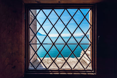 View of sea seen through window