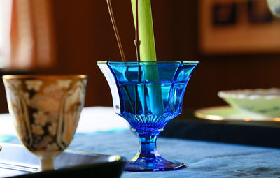 Close-up of blue glass on table