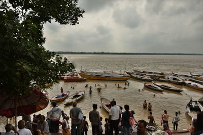 People on beach against sky