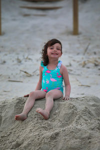 Happy girl on sand at beach