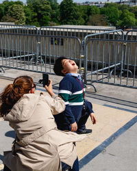 Rear view of woman photographing