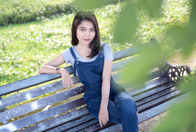 Portrait of young woman sitting on bench