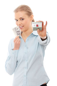 Portrait of a smiling young woman photographing against white background