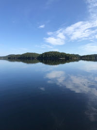 Scenic view of lake against blue sky